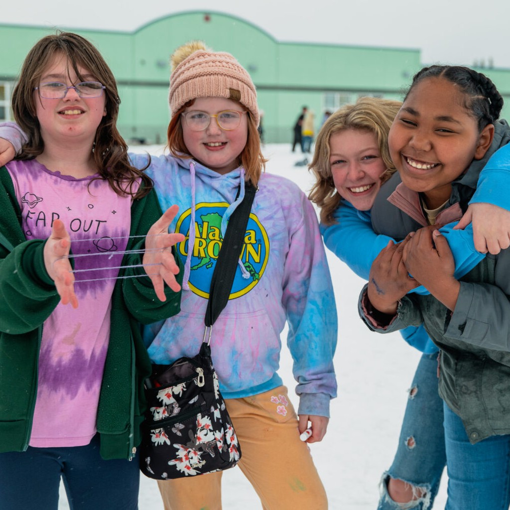 Students smiling on the snowy playground